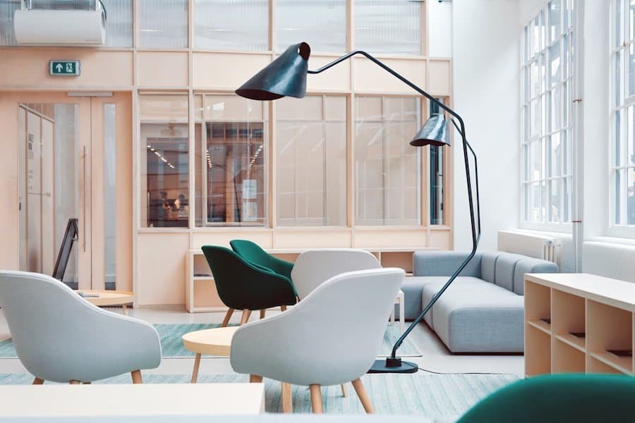 Modern office lounge with stylish furniture and large floor lamp.