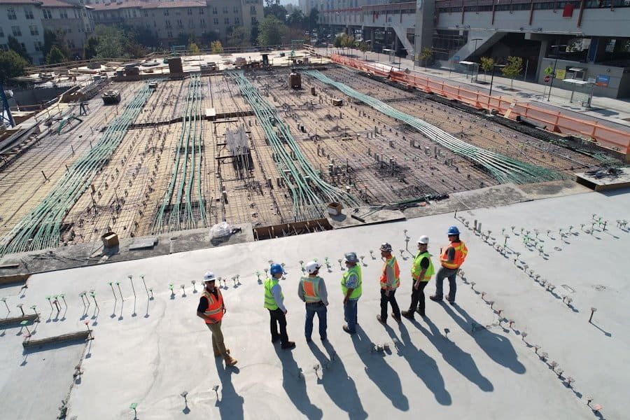 Construction workers overseeing progress at a large building site.