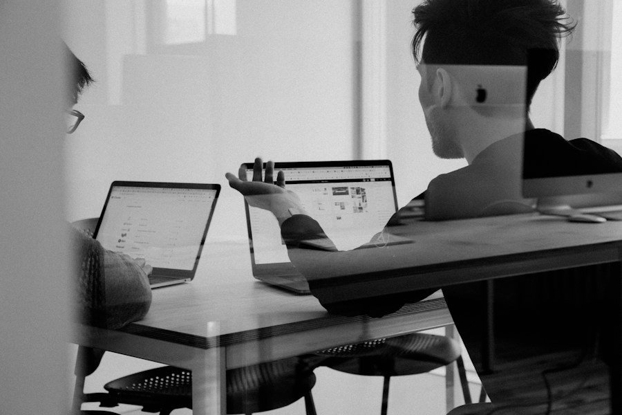 Man working on a laptop at a home office setup.