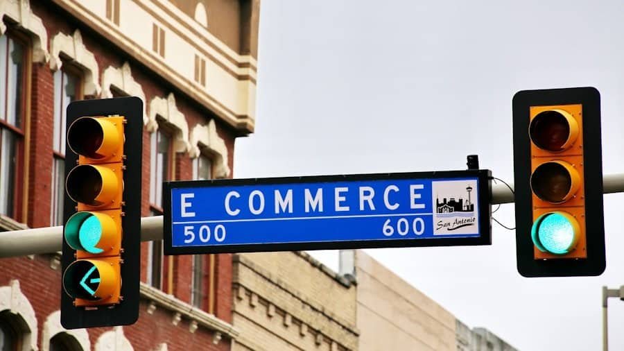 Traffic light showing green on east commerce street with buildings in the background.